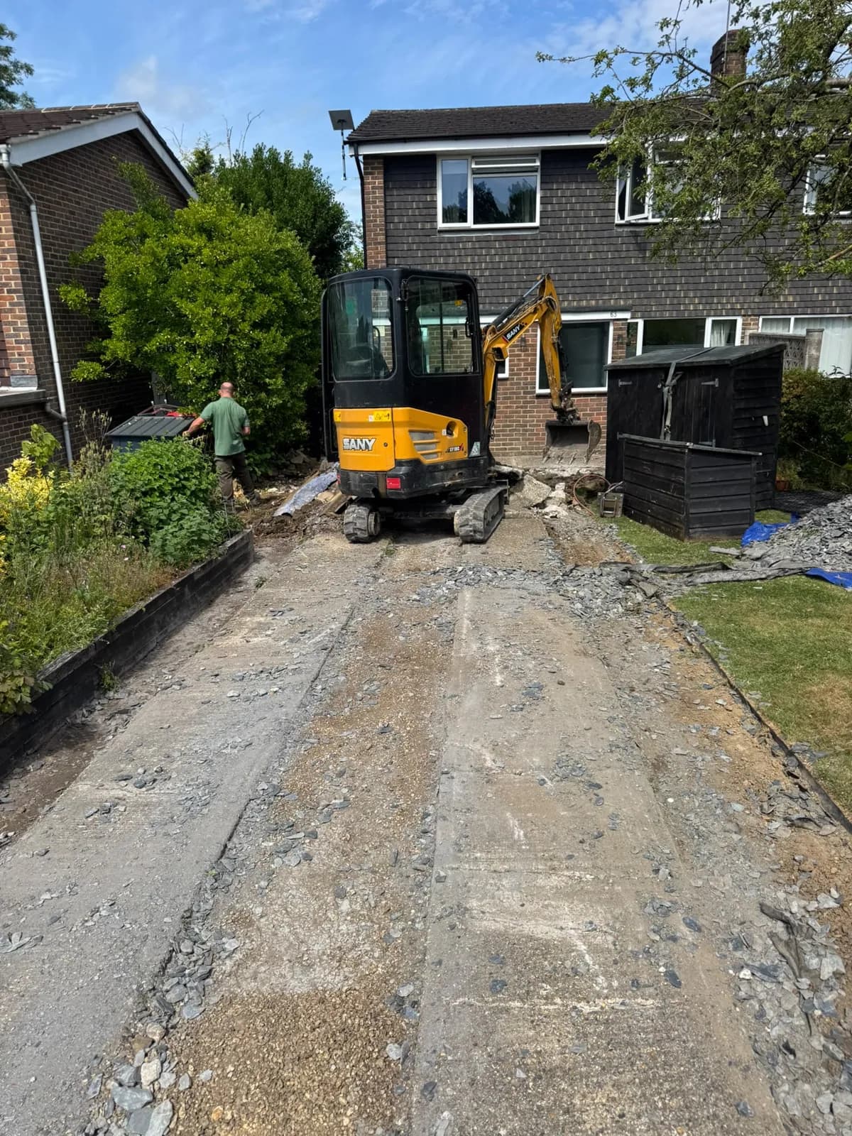 Our team digging a driveway out to formation with a mini-digger before the new base goes in.